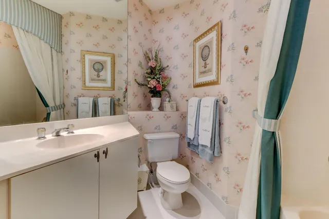 a bathroom with a toilet sink and mirror