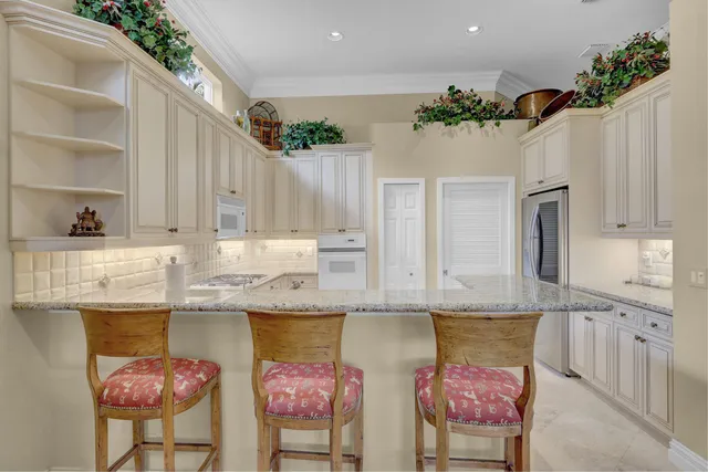 a kitchen with stainless steel appliances granite countertop a stove a sink and a cabinets