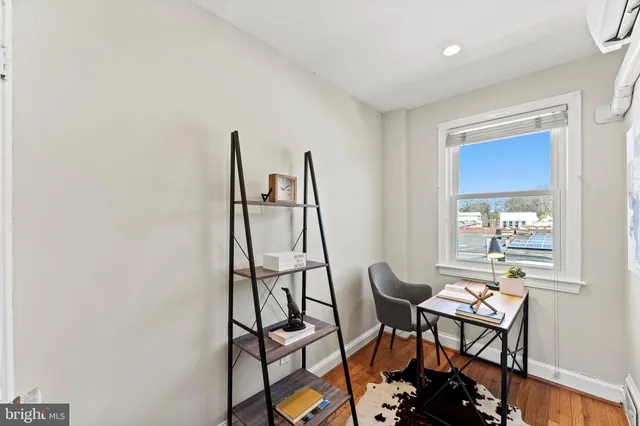 a view of entryway and hall with wooden floor