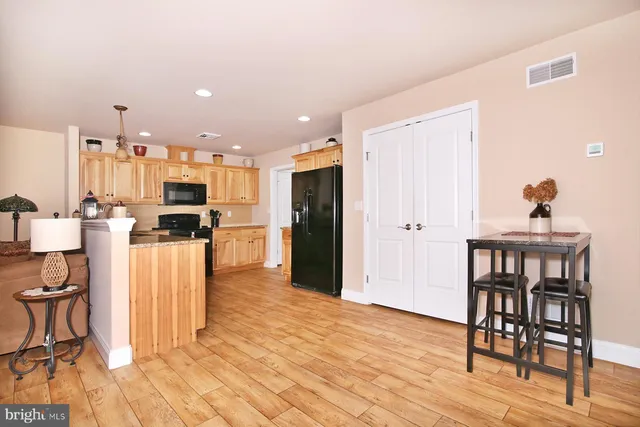 a dining room with furniture a rug and wooden floor