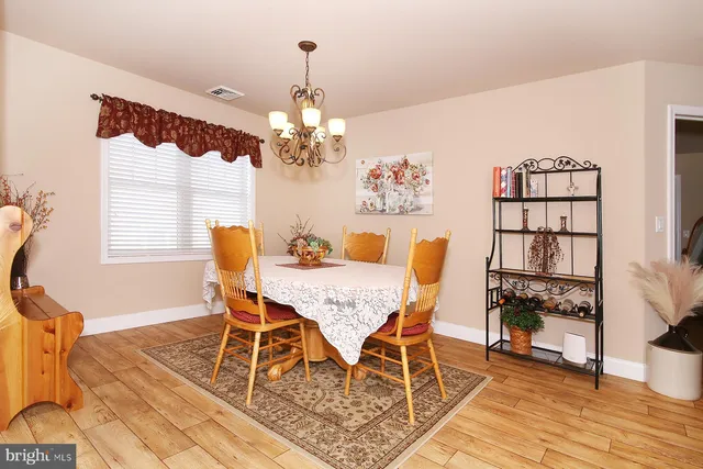 a living room with furniture and a dining table with kitchen view