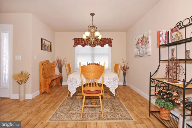 a living room with a fireplace and a painting on the wall