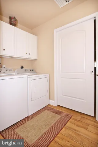 a spacious bedroom with a large bed and a chandelier