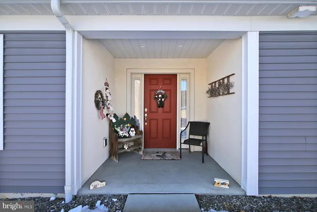 a kitchen with stainless steel appliances granite countertop a stove top oven a sink dishwasher and a refrigerator with wooden floor