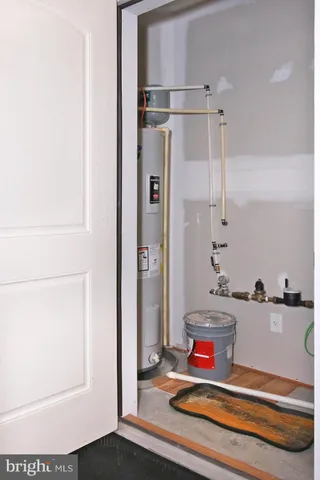 a view of a patio with table and chairs potted plants and large tree