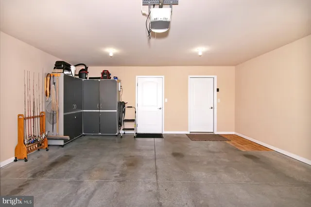 a front view of a house with garden and trees