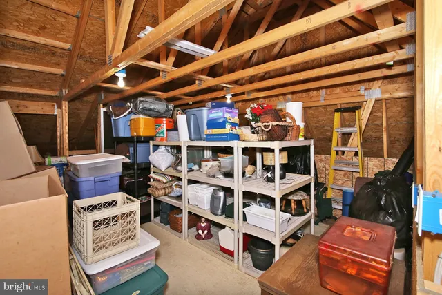 a view of a wooden deck and lake with trees in the background