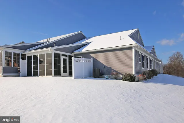 a kitchen with kitchen island granite countertop a sink cabinets and stainless steel appliances