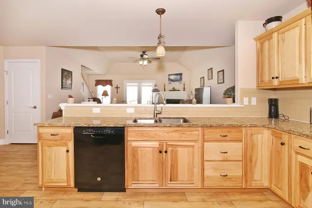 a kitchen with stainless steel appliances kitchen island granite countertop a refrigerator and a stove top oven