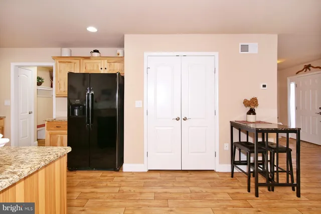a view of a room with wooden floor and potted plant
