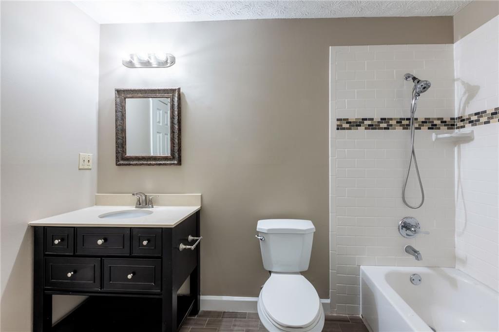 143 Swanson Road Fayetteville, GA 30214 - Photo 20 of 27 a bathroom with a toilet sink and mirror