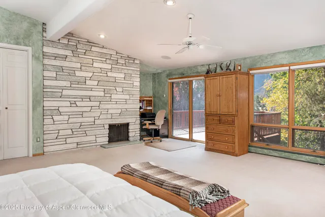 a spacious bathroom with a granite countertop sink and a mirror