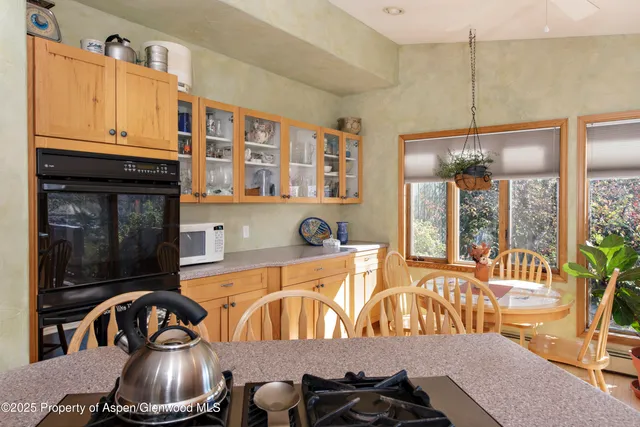 a view of a refrigerator in kitchen and wooden floor