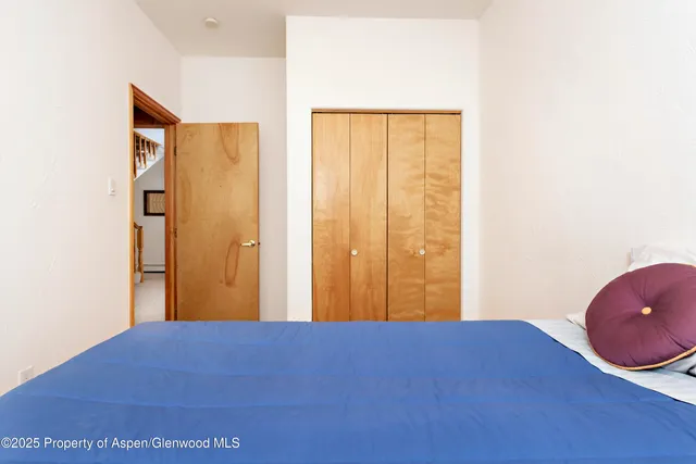 a bathroom with a granite countertop sink mirror vanity and toilet
