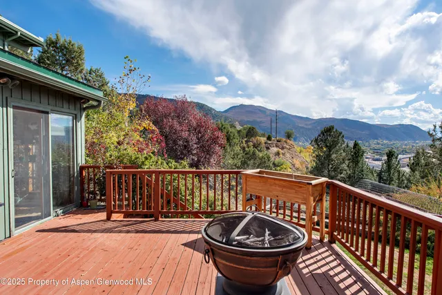 a view of a balcony with chair and wooden floor