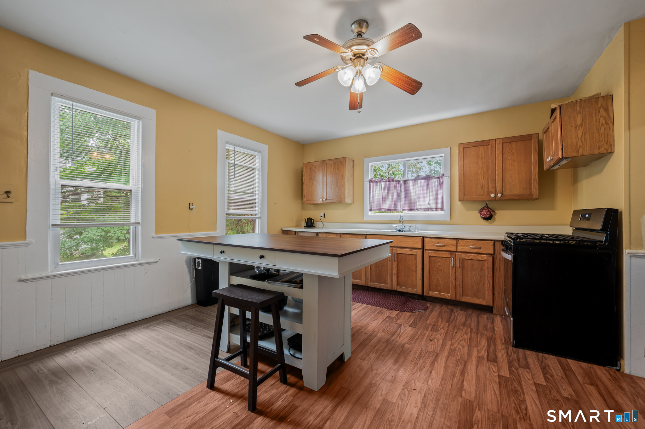 220 Murray Street Meriden, CT 06450 - Photo 4 of 28 a kitchen with a table chairs sink and cabinets
