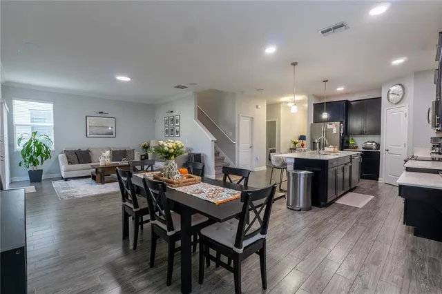 a kitchen with a sink cabinets and wooden floor