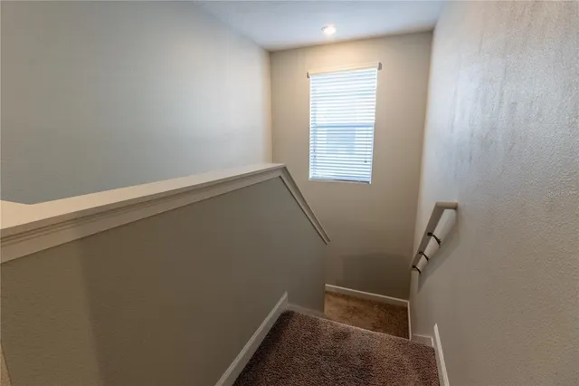 a bed room with a bed tv and a window