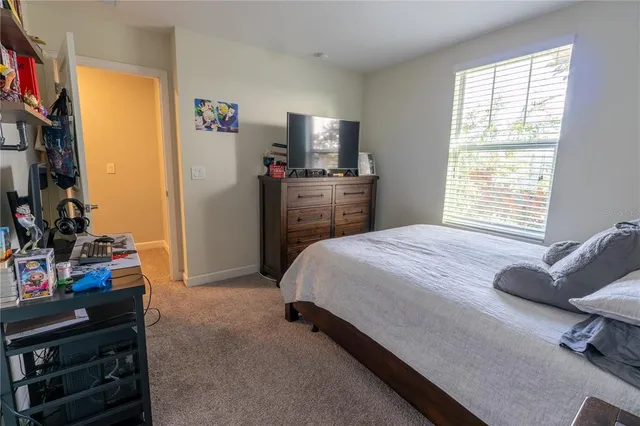 a bed sitting in a bedroom next to a window