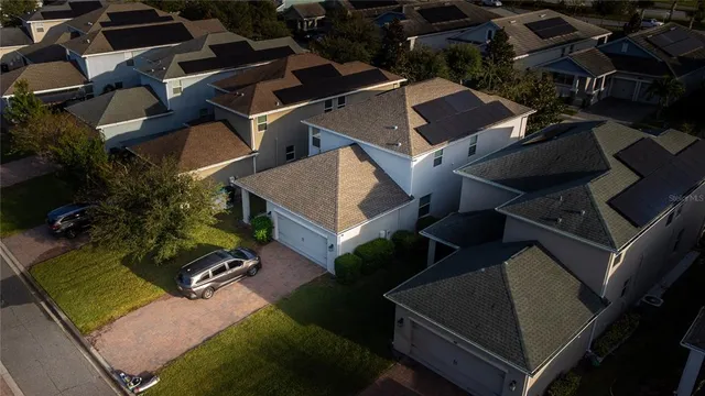 an aerial view of a house with a yard