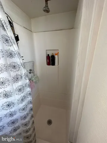 a bedroom with a bed and mirror