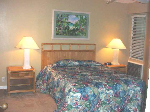 2777 South Kihei Road, Unit D104 Kihei, HI 96753 - Photo 4 of 8 a bedroom with a bed and a lamp