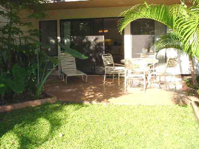 2777 South Kihei Road, Unit D104 Kihei, HI 96753 - Photo 8 of 8 a view of a patio with table and chairs with plants and wooden fence