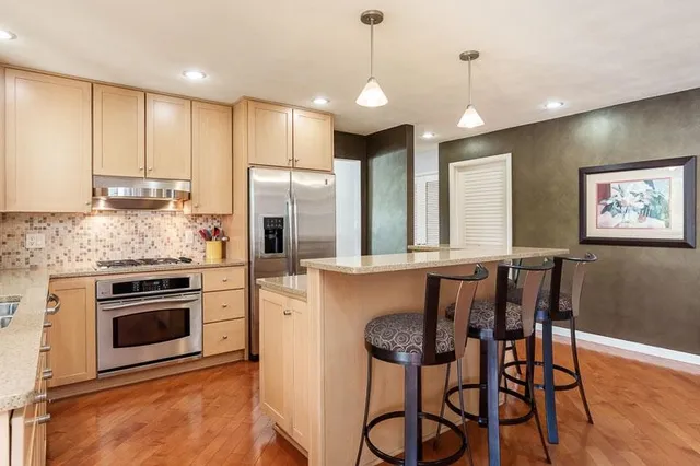 a dining room with furniture a large window and chairs
