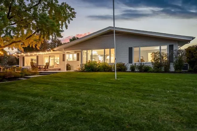 a front view of house with yard and green space