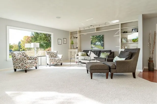 a view of a workspace with furniture and a window