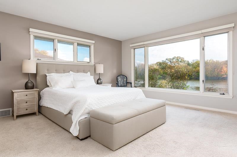 2303 Rock Terrace Rockford, IL 61103 - Photo 50 of 70 a large white bed sitting in a bedroom next to a window