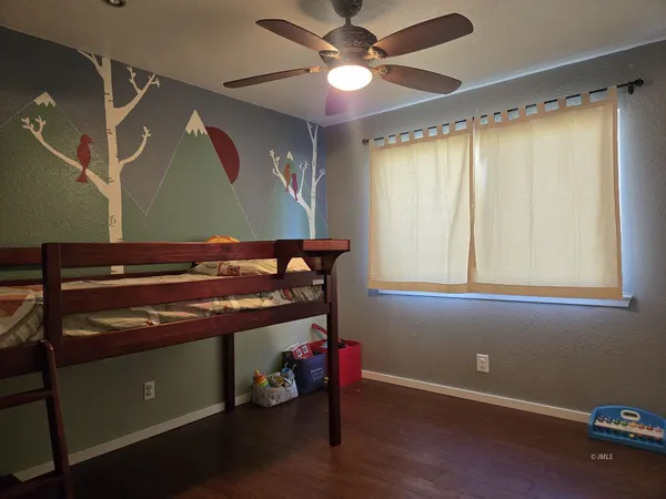 a room with wooden floors and a window