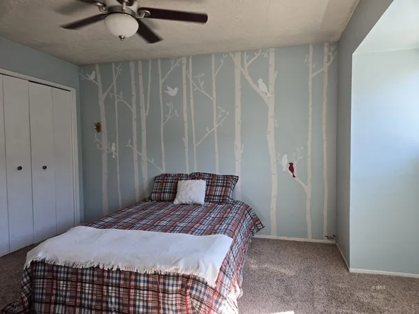 a bedroom with a bed and cabinets
