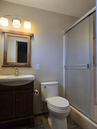a bathroom with a sink toilet and mirror