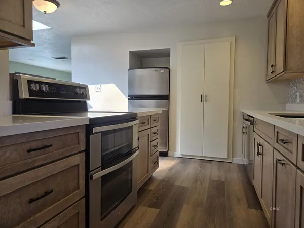 a kitchen with stainless steel appliances a stove microwave and cabinets