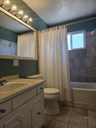 a bathroom with a sink a toilet and bathtub