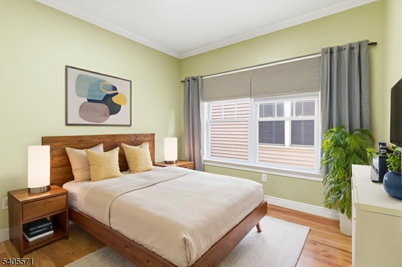 21 Freeman Street, Unit A2 Newark, NJ 07105 - Photo 12 of 24 a bedroom with a bed and a painting on the wall