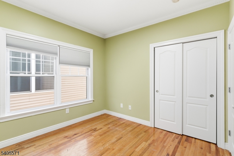 21 Freeman Street, Unit A2 Newark, NJ 07105 - Photo 13 of 24 a view of an empty room with wooden floor and a window