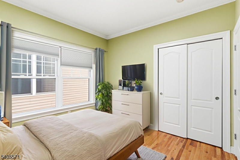 21 Freeman Street, Unit A2 Newark, NJ 07105 - Photo 14 of 24 a bedroom with a bed and a flat screen tv