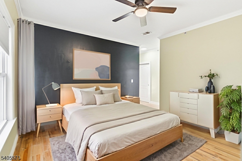 21 Freeman Street, Unit A2 Newark, NJ 07105 - Photo 16 of 24 a bedroom with a bed and a chandelier