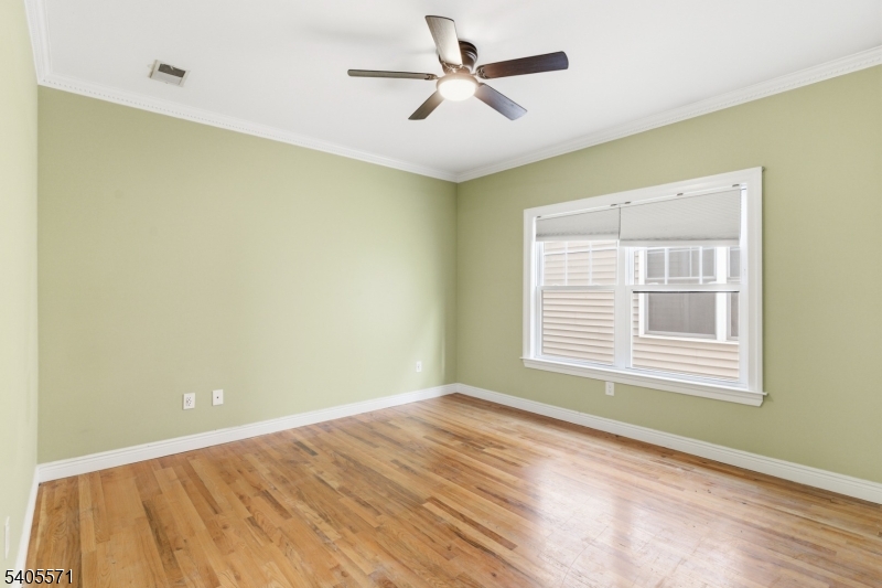 21 Freeman Street, Unit A2 Newark, NJ 07105 - Photo 17 of 24 a view of a big room with windows and chandelier fan