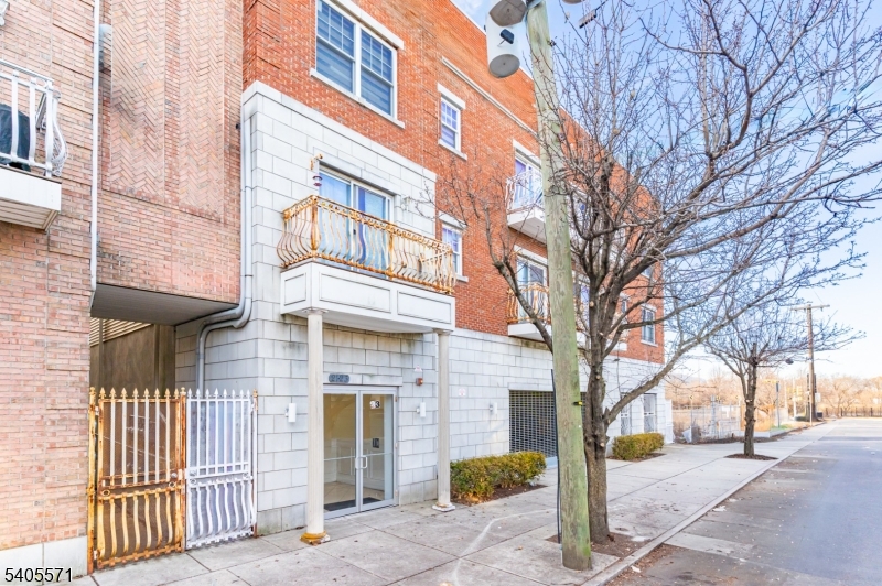 21 Freeman Street, Unit A2 Newark, NJ 07105 - Photo 23 of 24 a front view of a building with a tree