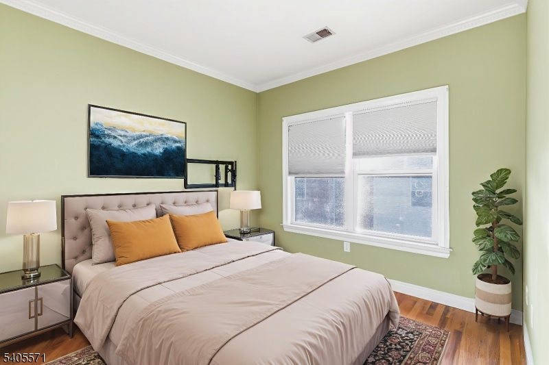 21 Freeman Street, Unit A2 Newark, NJ 07105 - Photo 4 of 24 a bedroom with a bed and a painting on the wall