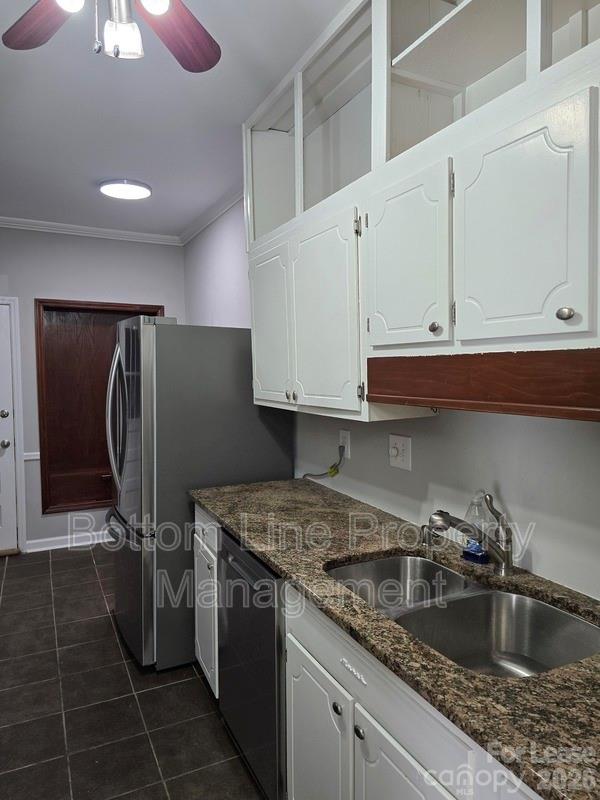 5949 Quail Hollow Road, Unit D Charlotte, NC 28210 - Photo 11 of 34 a kitchen with granite countertop a sink a stove and refrigerator