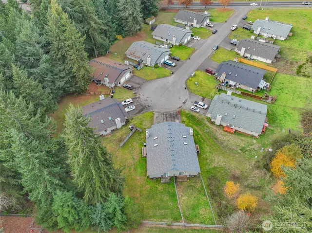 an aerial view of a house with a yard