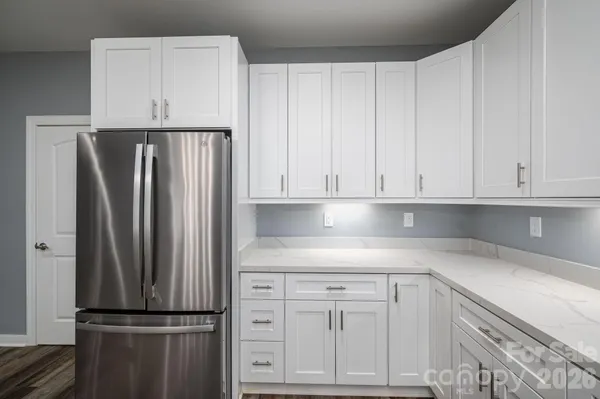 a kitchen with white cabinets and a stove