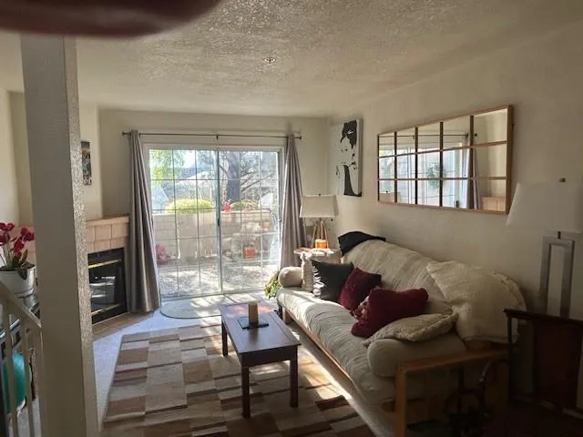 a living room with furniture and a floor to ceiling window