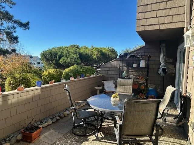 a view of a balcony with table and chairs