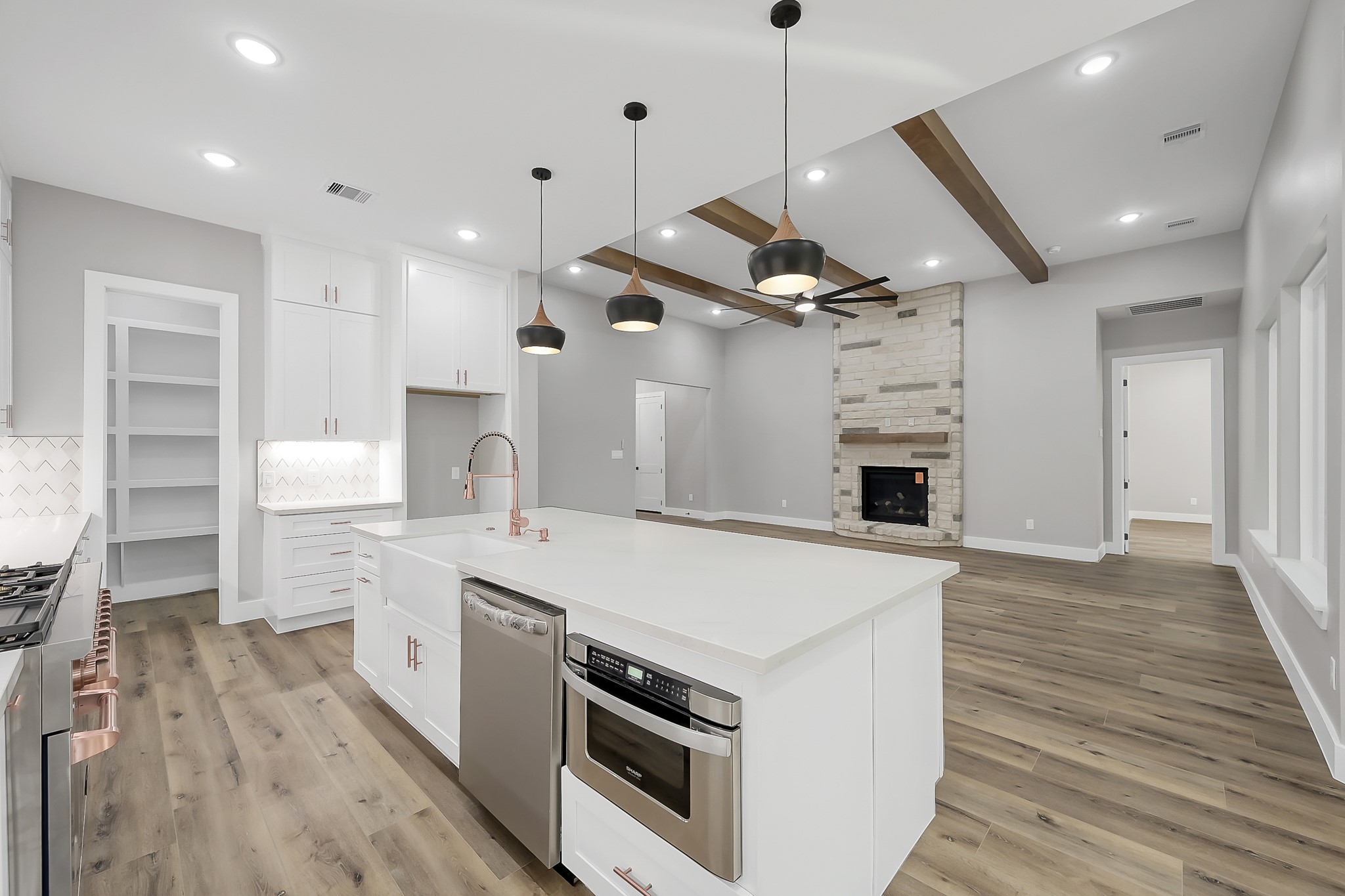 135 Wick Willow Road Montgomery, TX 77356 - Photo 16 of 50 a kitchen with a stove a sink and a refrigerator