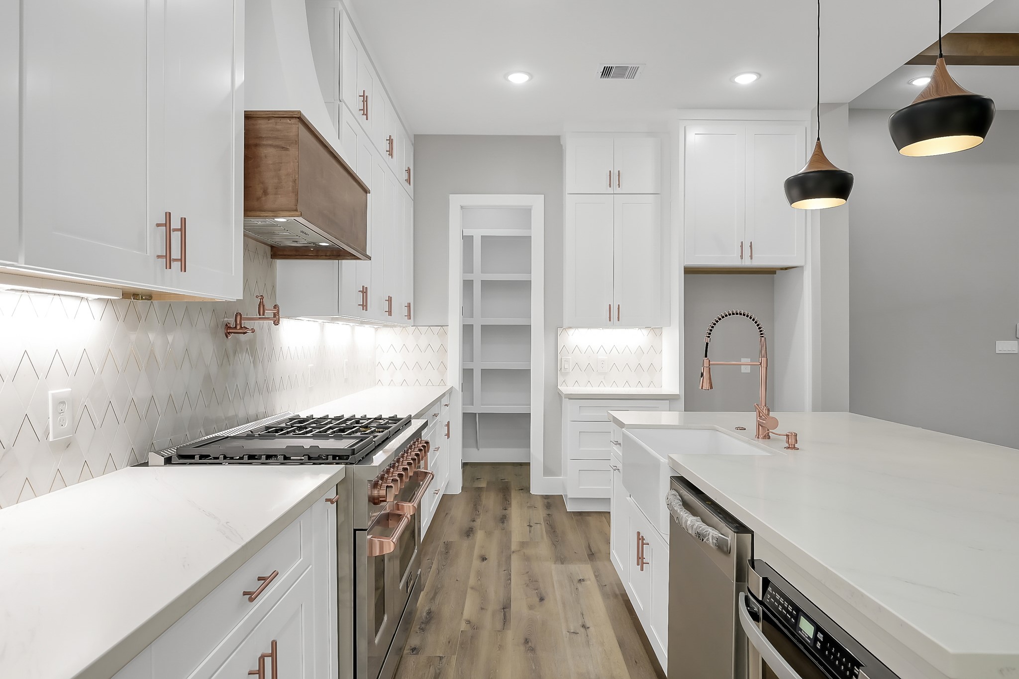 135 Wick Willow Road Montgomery, TX 77356 - Photo 17 of 50 a kitchen with a sink stainless steel appliances and cabinets